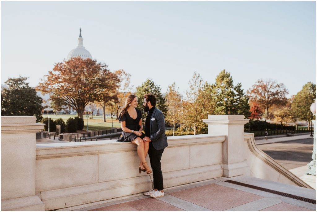 bride and groom lean against wall at Capitol Building