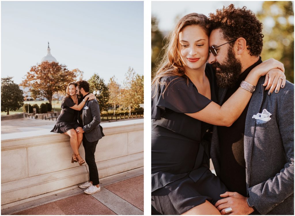 bride sits on wall at Capitol while groom hugs her