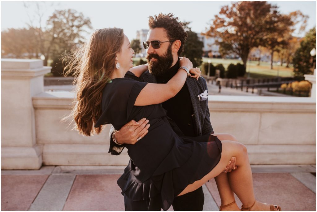 groom lifts bride during Capitol Hill engagement session