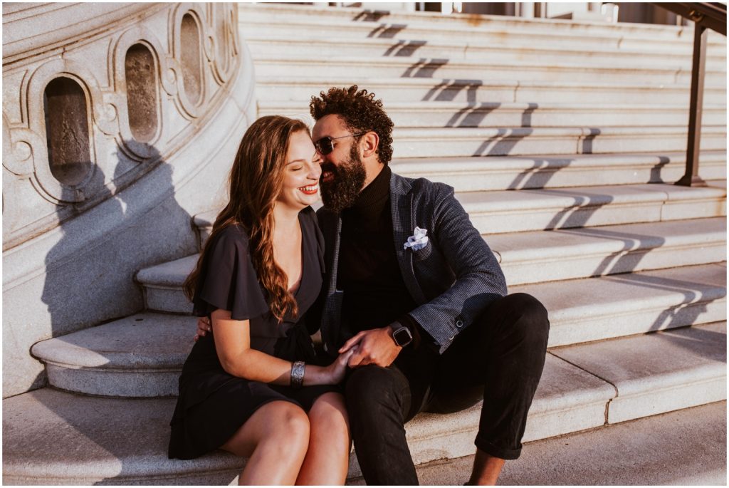 groom whispers in bride's ear during DC engagement photos