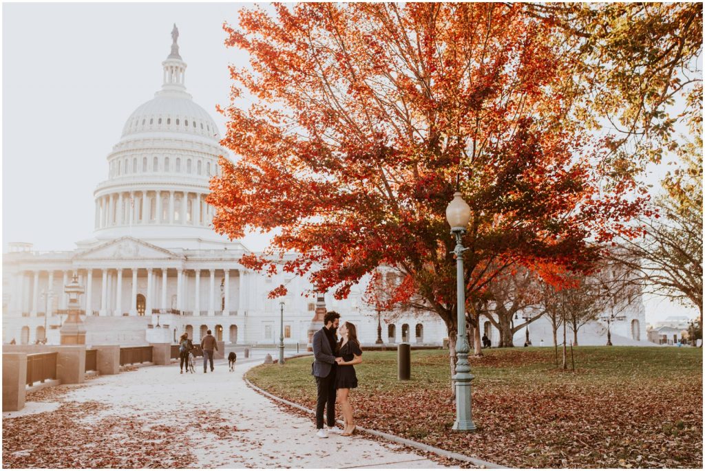 bride and groom pose near US Capitol during DC engagement session