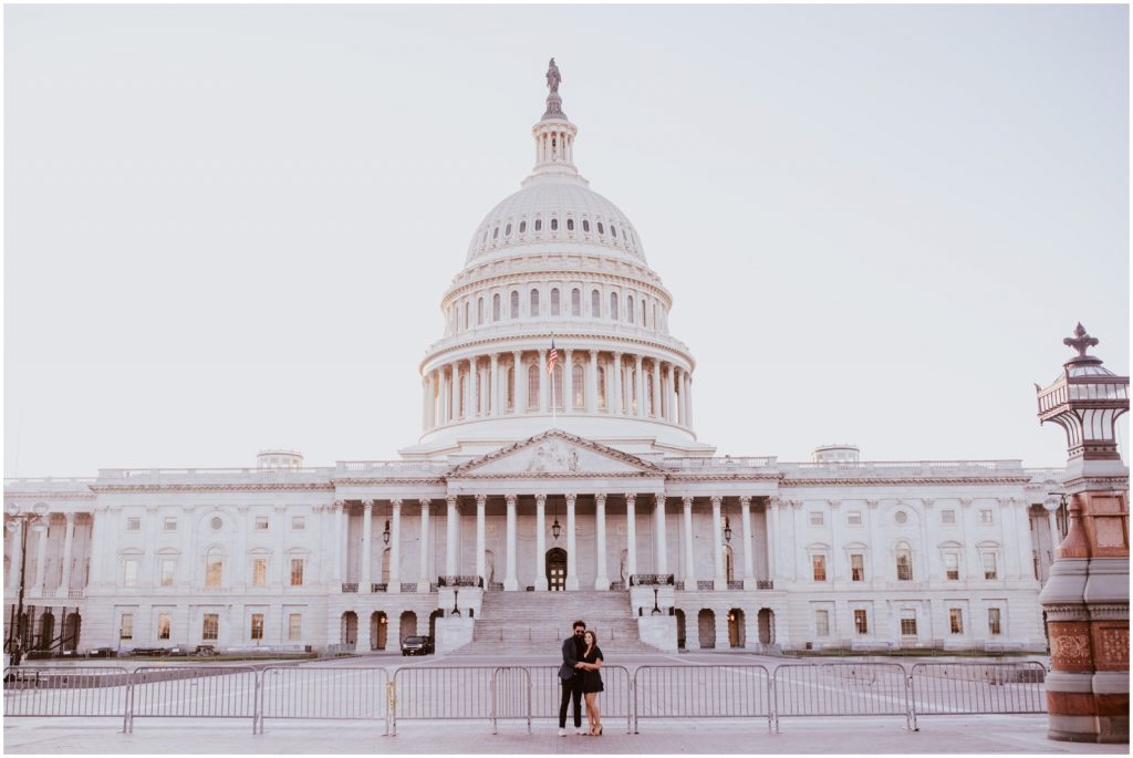bride and groom pose in front of US Capitol during engagement photos