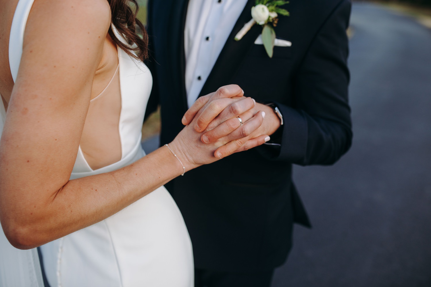 bride and groom holding hands