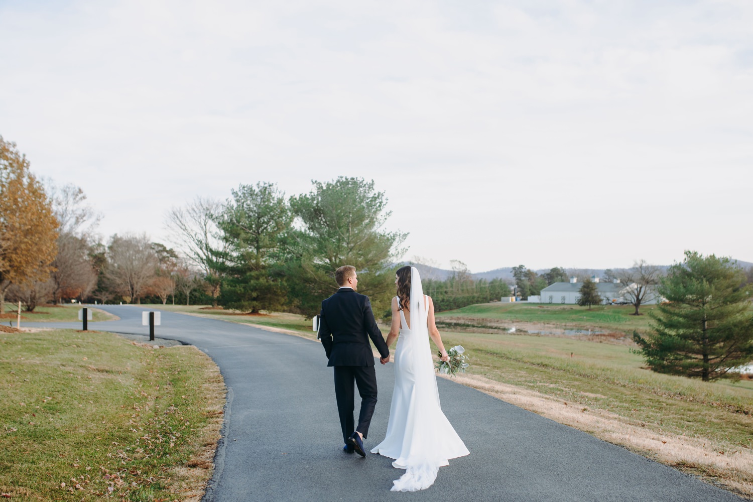 bride and groom walking in driveway