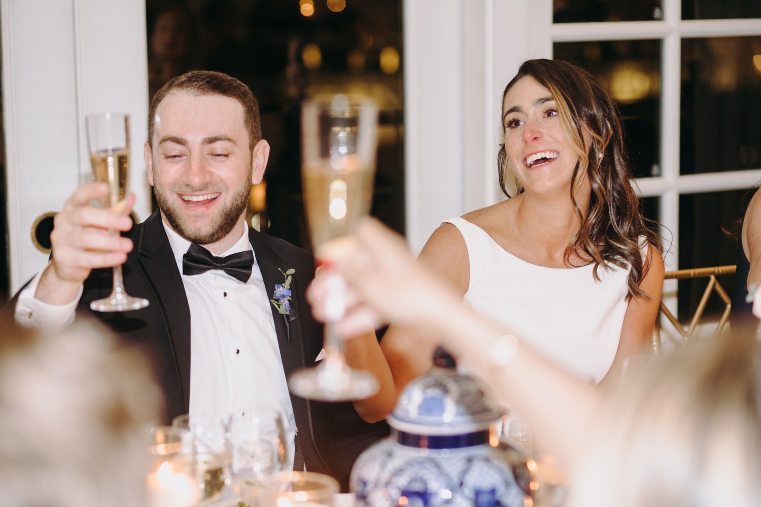 bride and groom laugh at speech