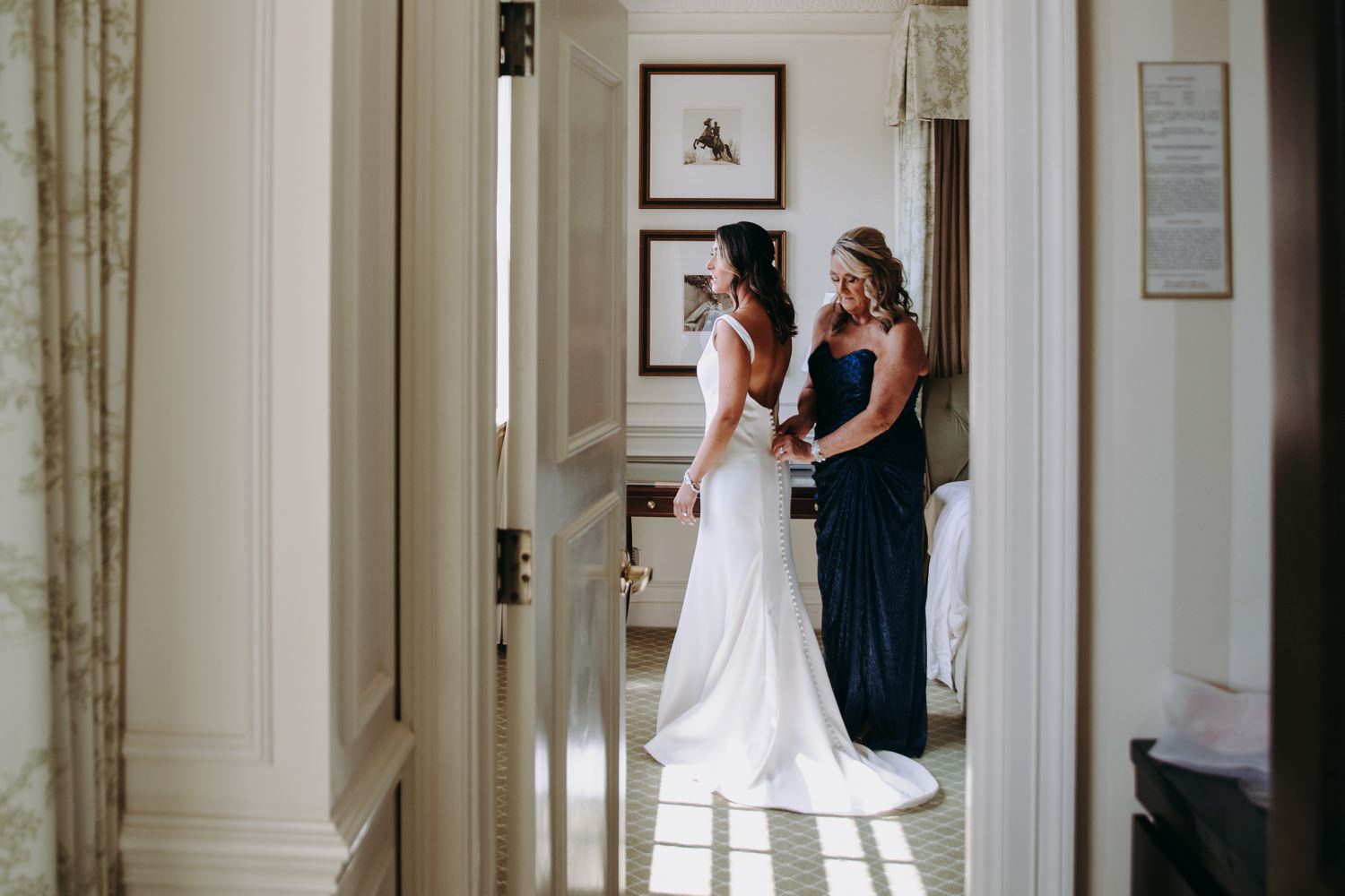 putting on wedding dress