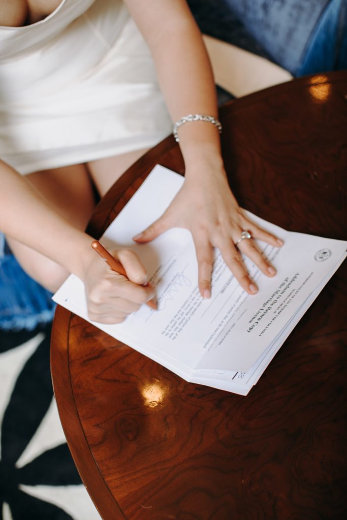 bride signs paper