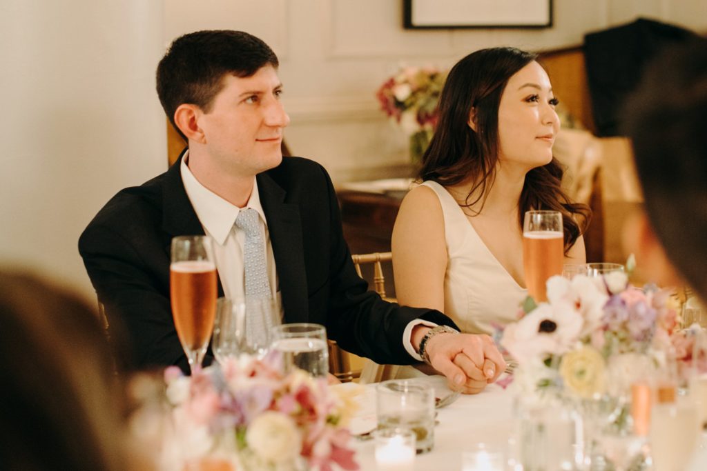 bride and groom watch toasts