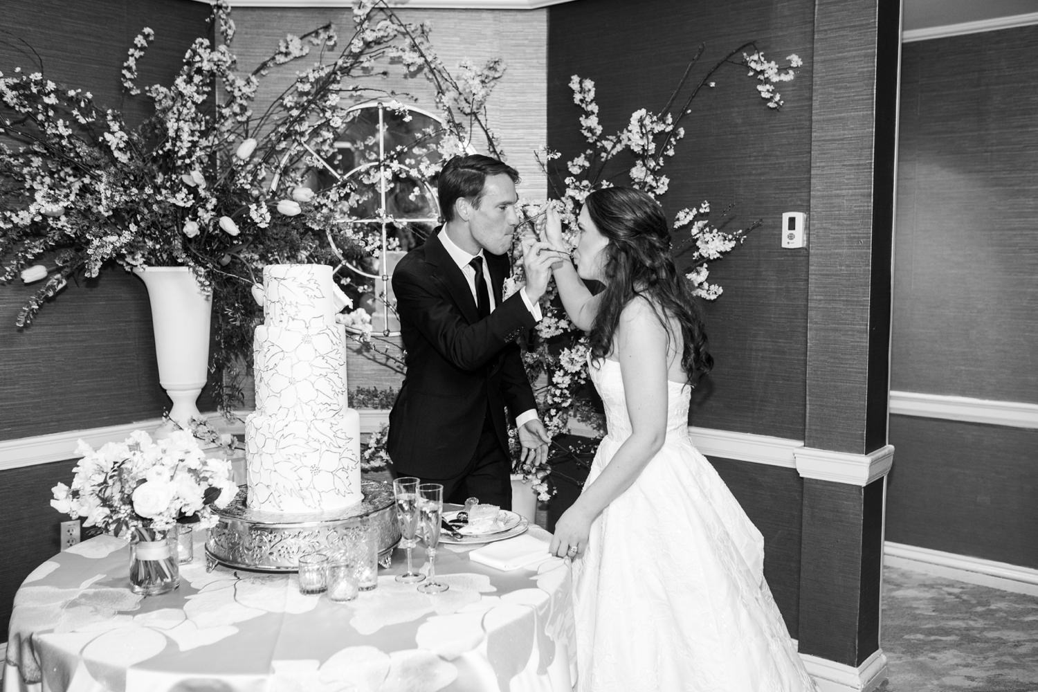 bride and groom feed each other cake