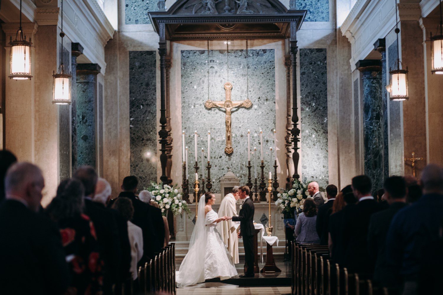 bride and groom holding hands in church