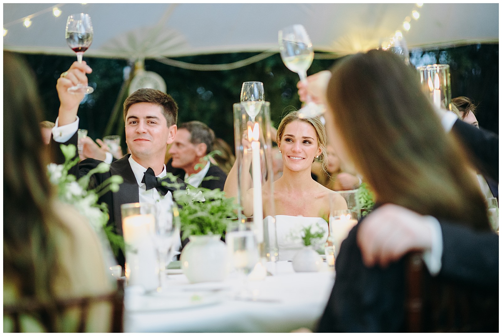 bride and groom cheers at their reception table