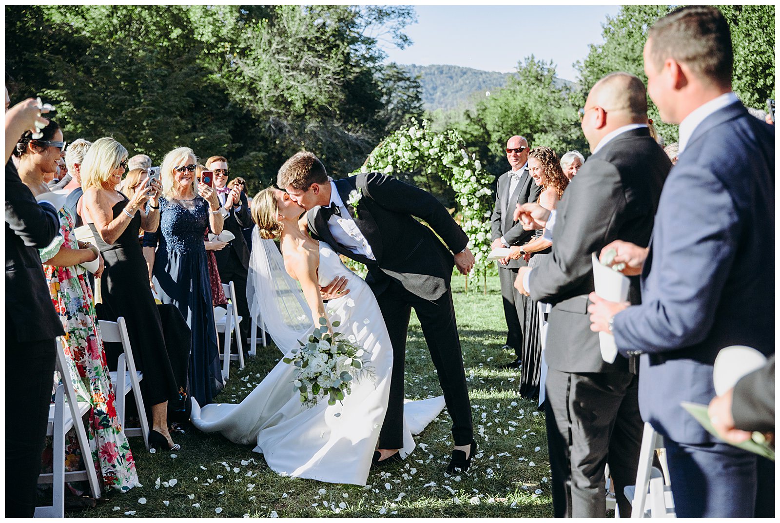 bride and groom kiss down the aisle