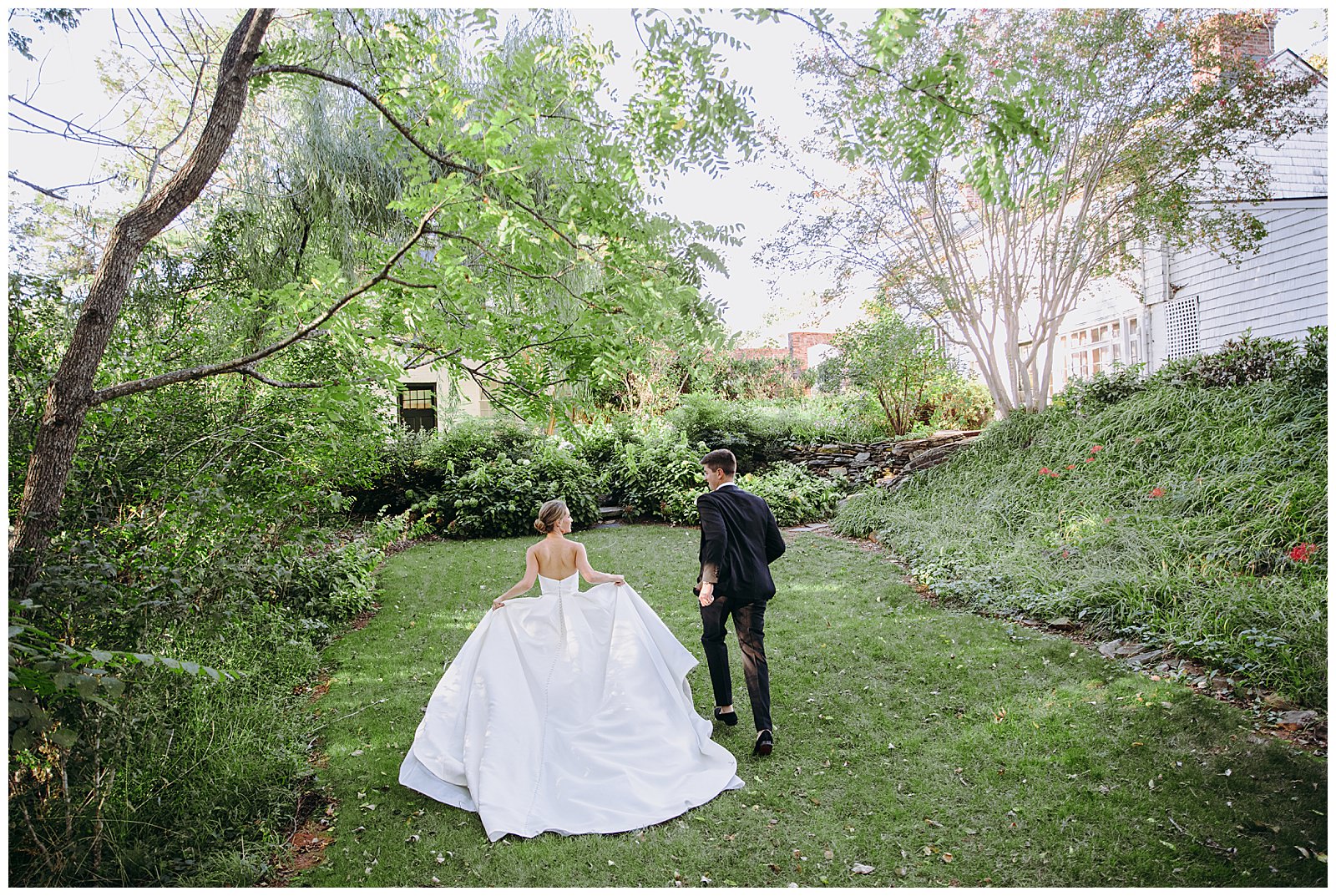 bride and groom running through the greenery in Charlottesville