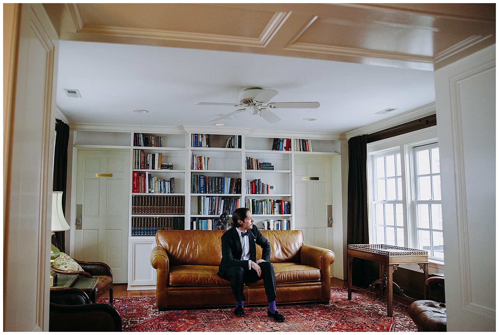 veritas wedding groom sitting candid photo looking out the window