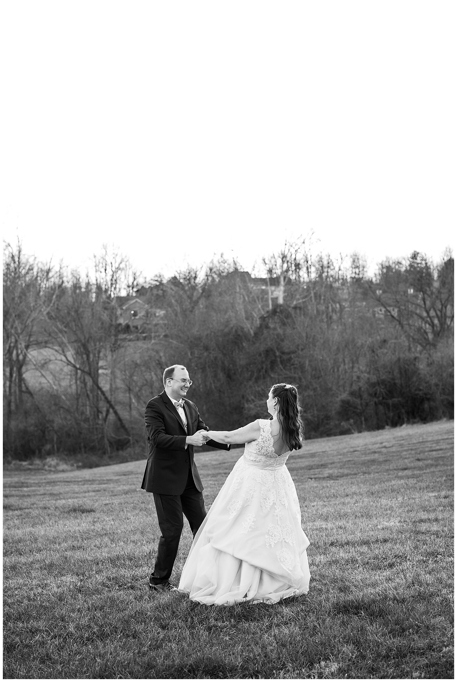 black and white photo of bride and groom spinning