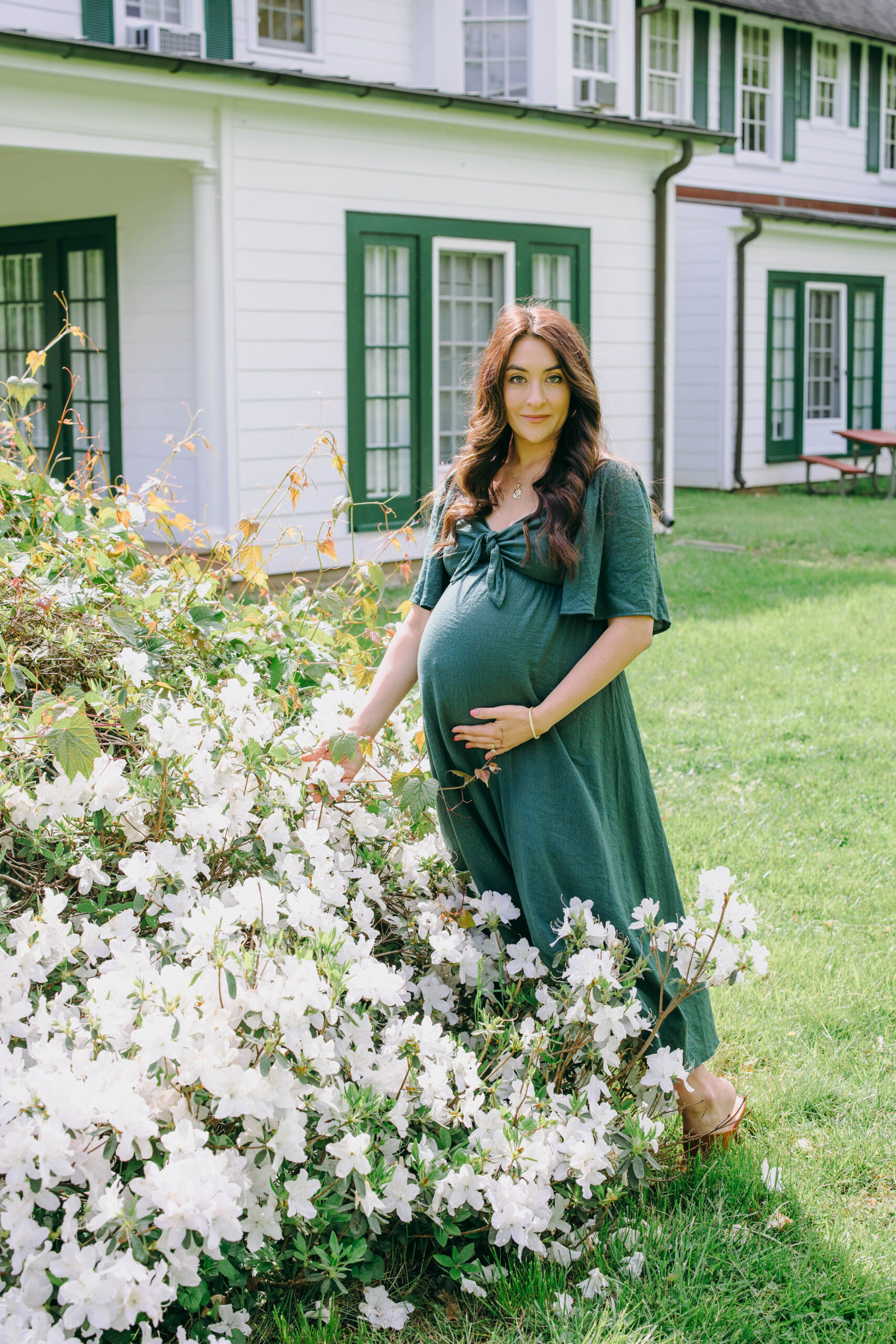 maternity photo of mother next to flowers