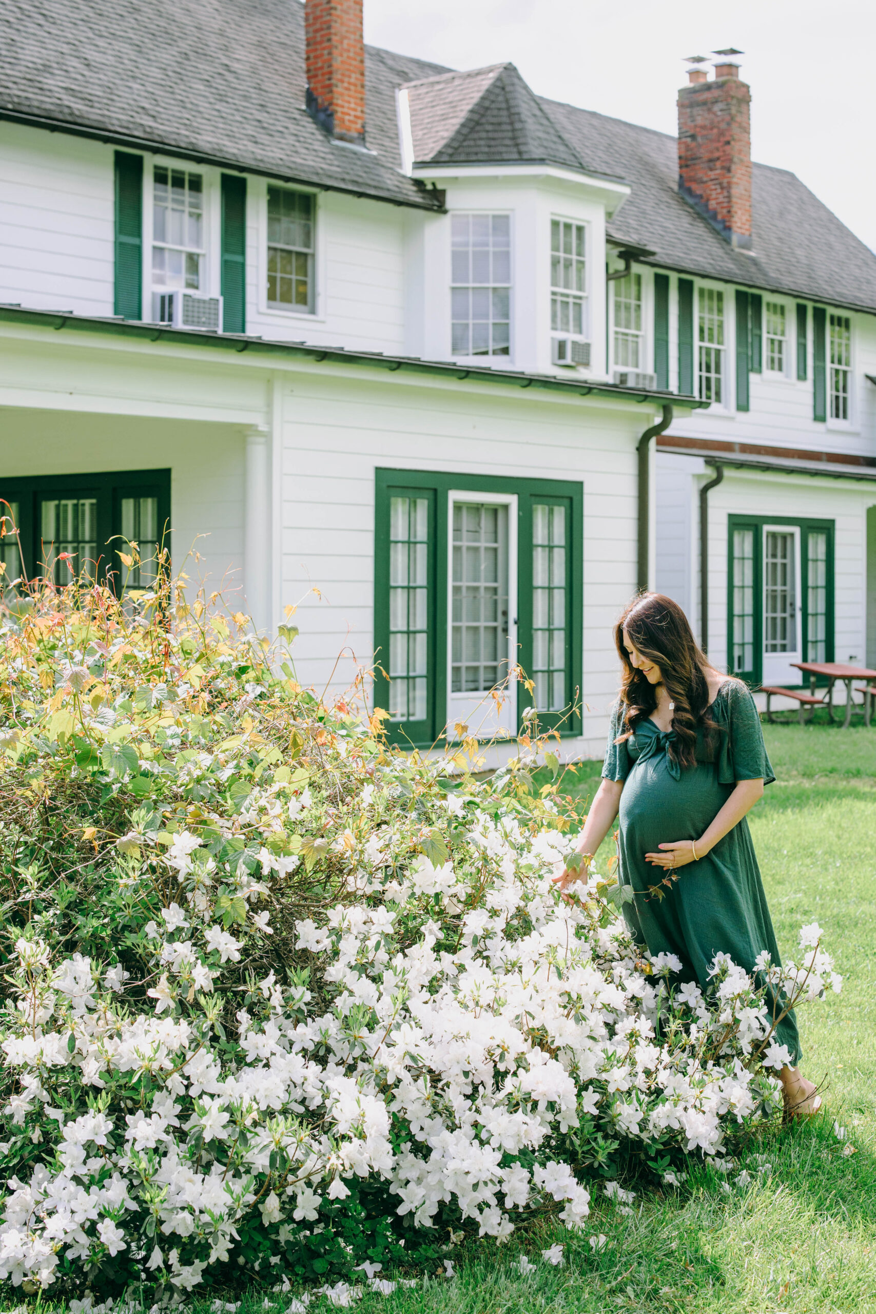 maternity photo of mother next to flowers