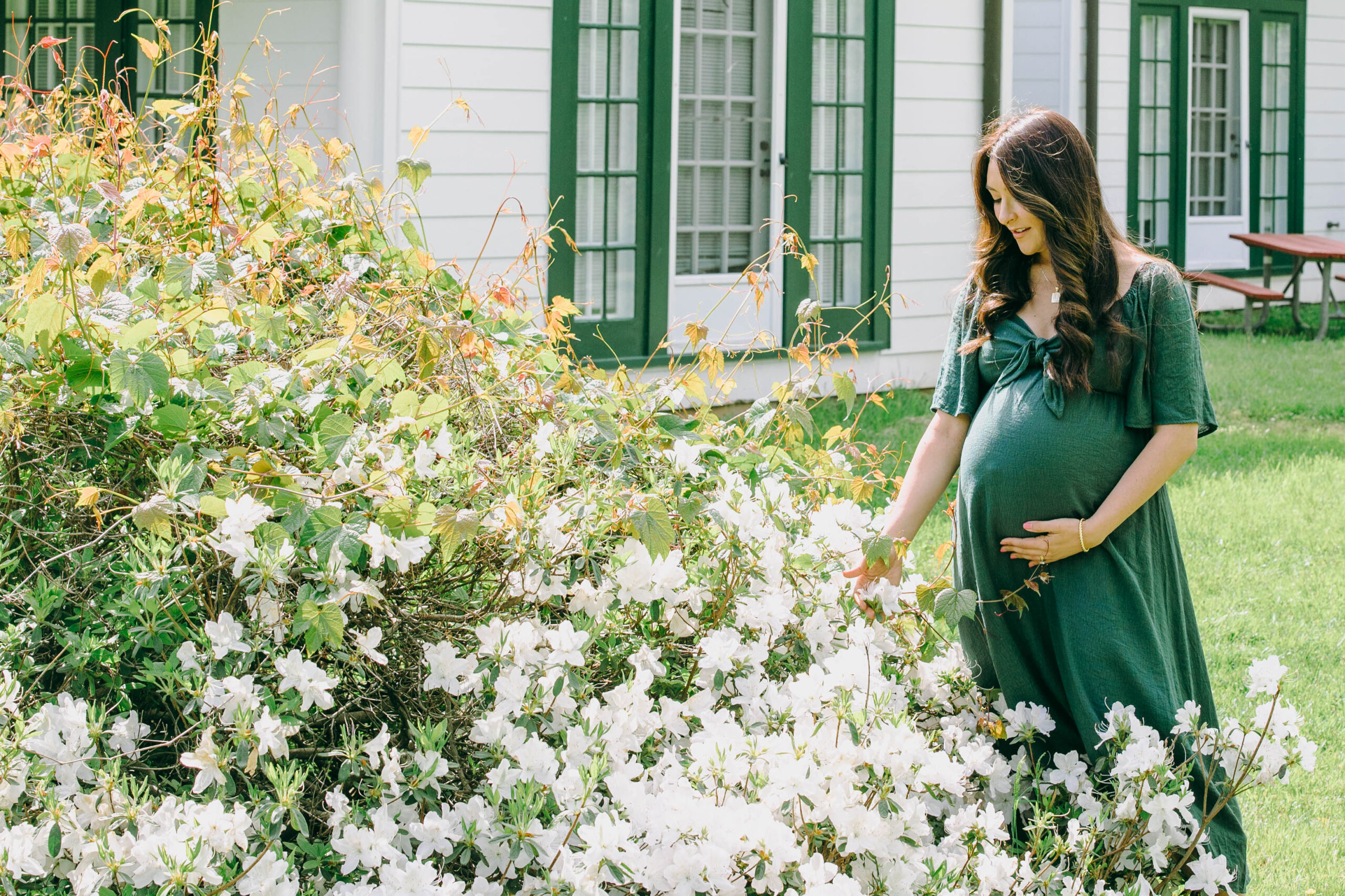 maternity photo of mother next to flowers