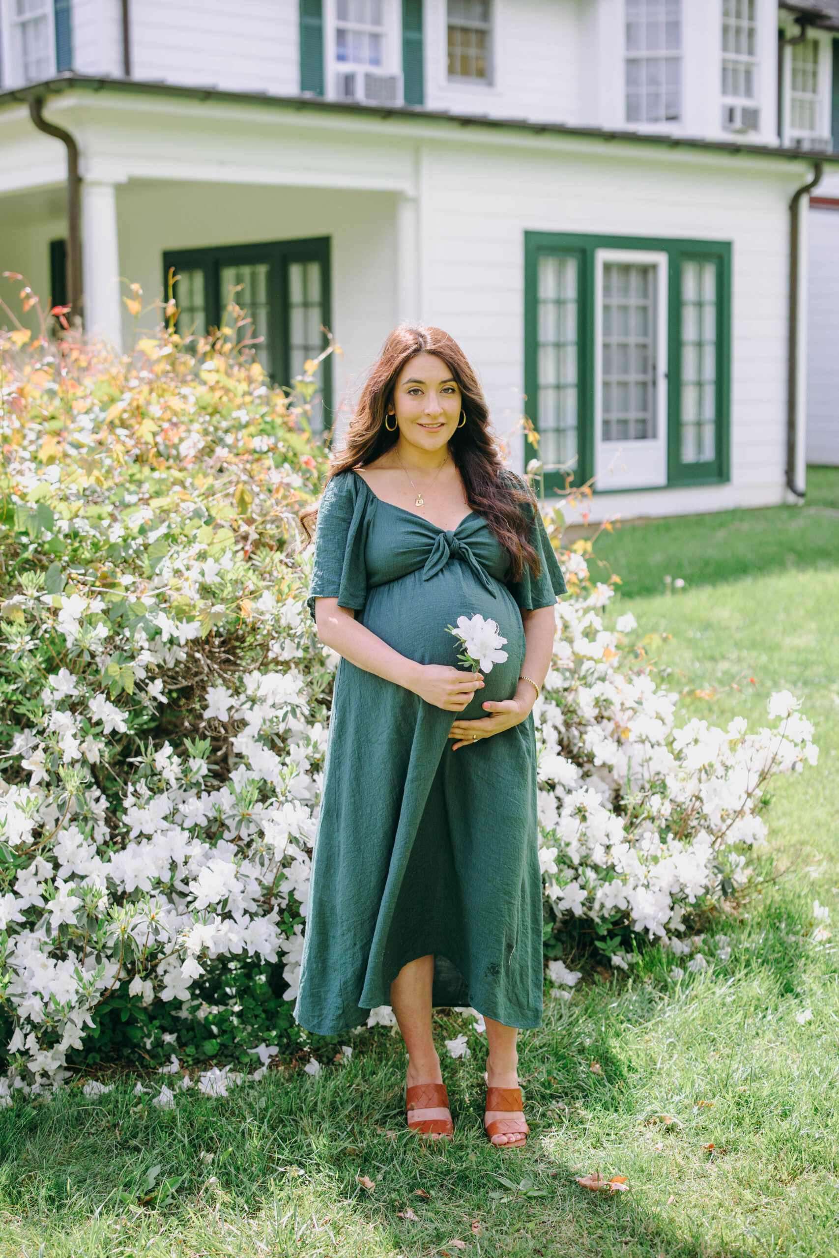 maternity photo of mother next to flowers in black and white