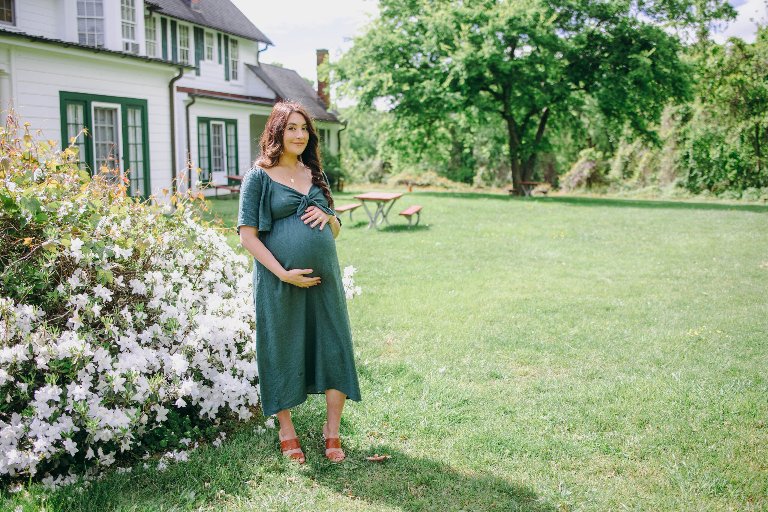 maternity photo of mother next to flowers in black and white