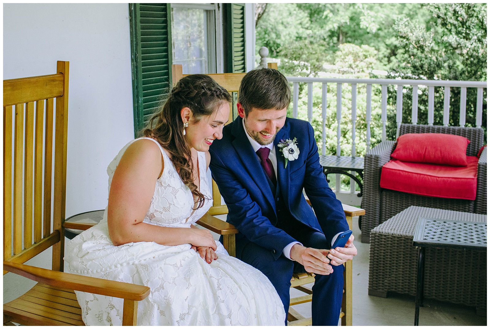 bride and groom look at phone