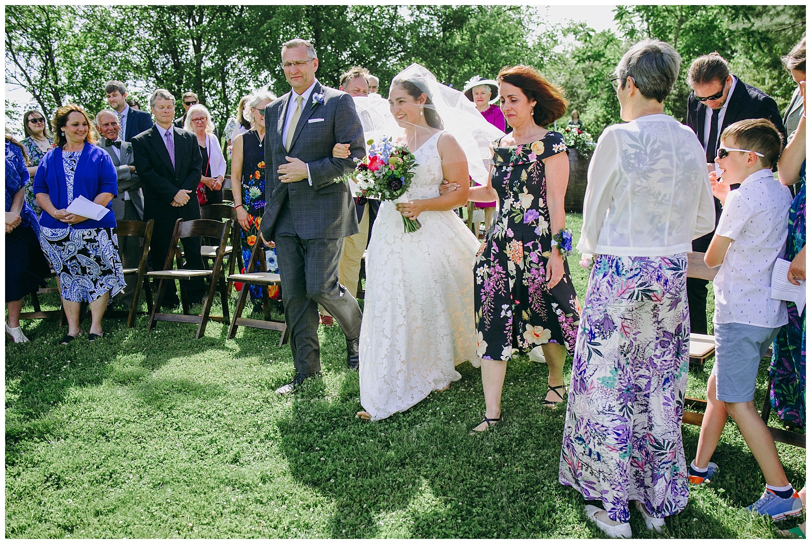 mom and dad walking bride down aisle