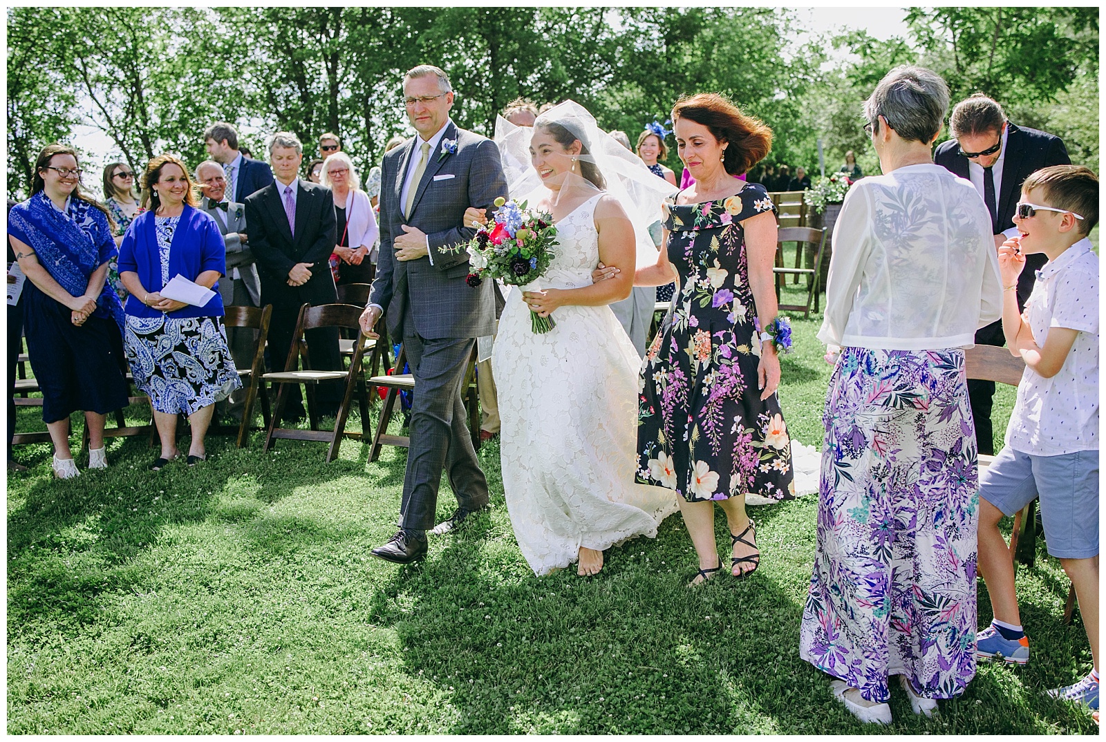 mom and dad walking bride down aisle