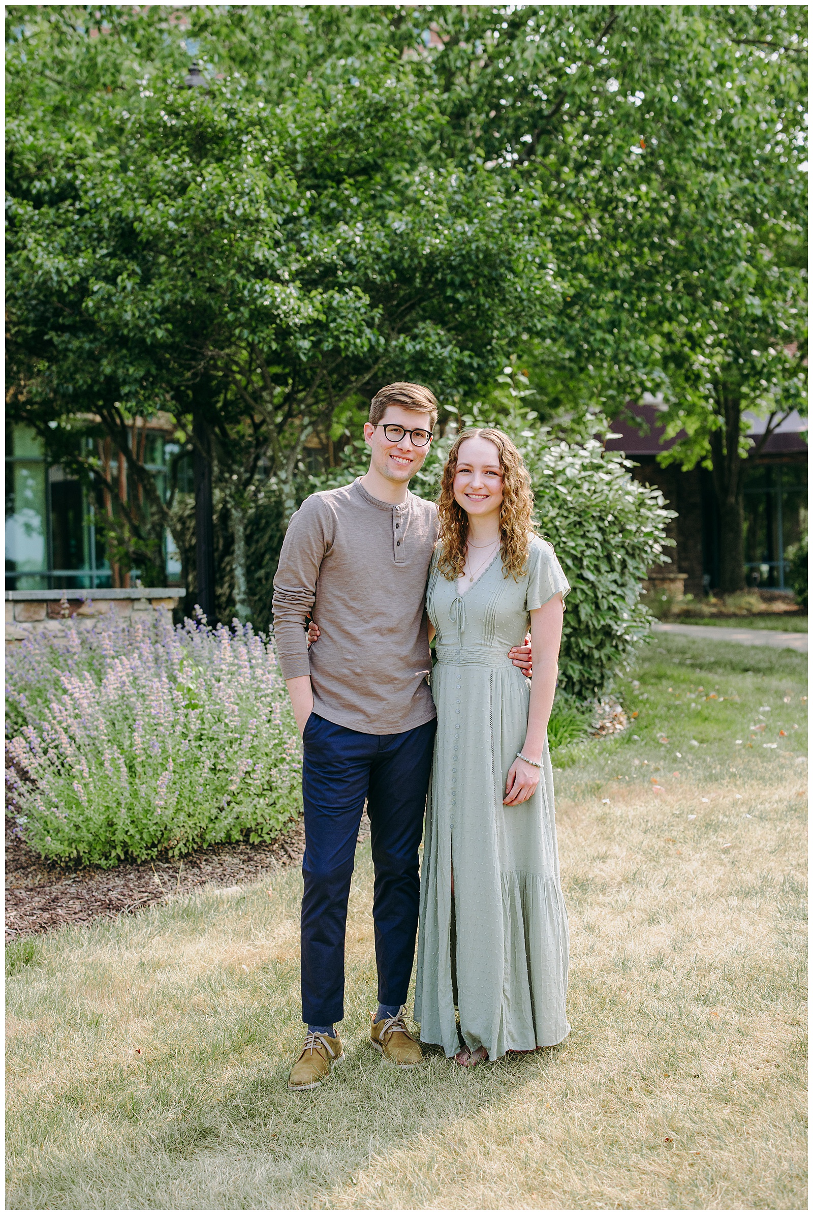 couple at Landsdowne with purple flowers and tall grass behind them