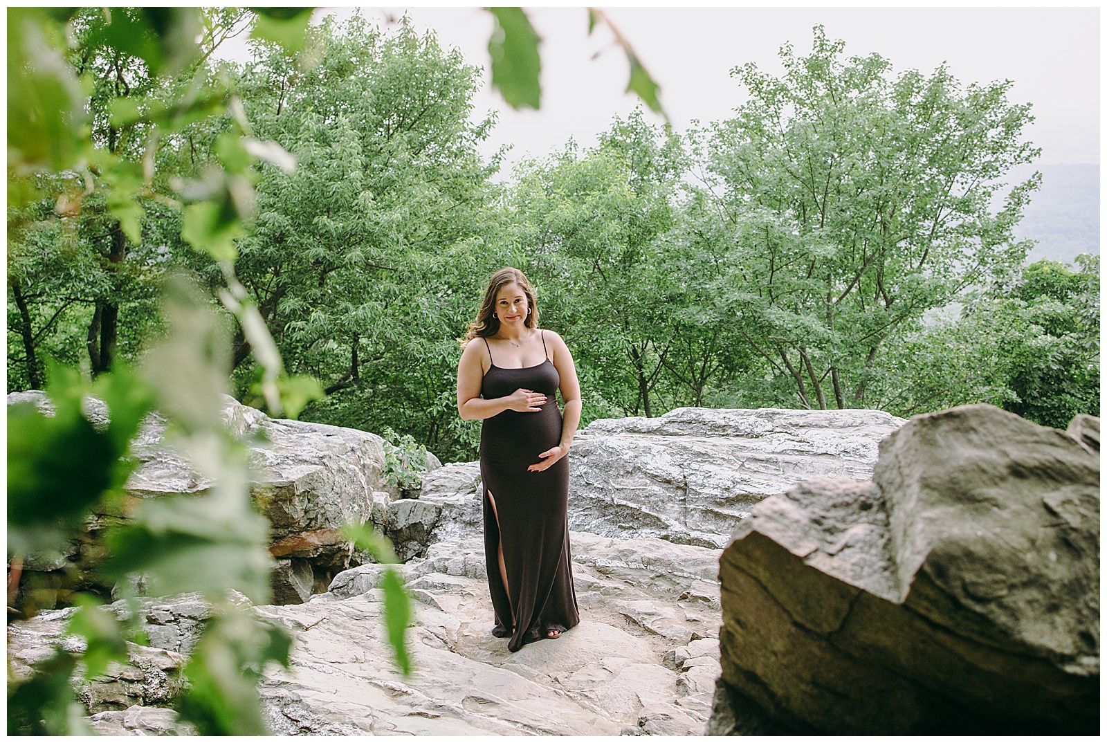 woman poses for individual photos at her maternity session, she is wearing a black maxi dress, Maternity Photos