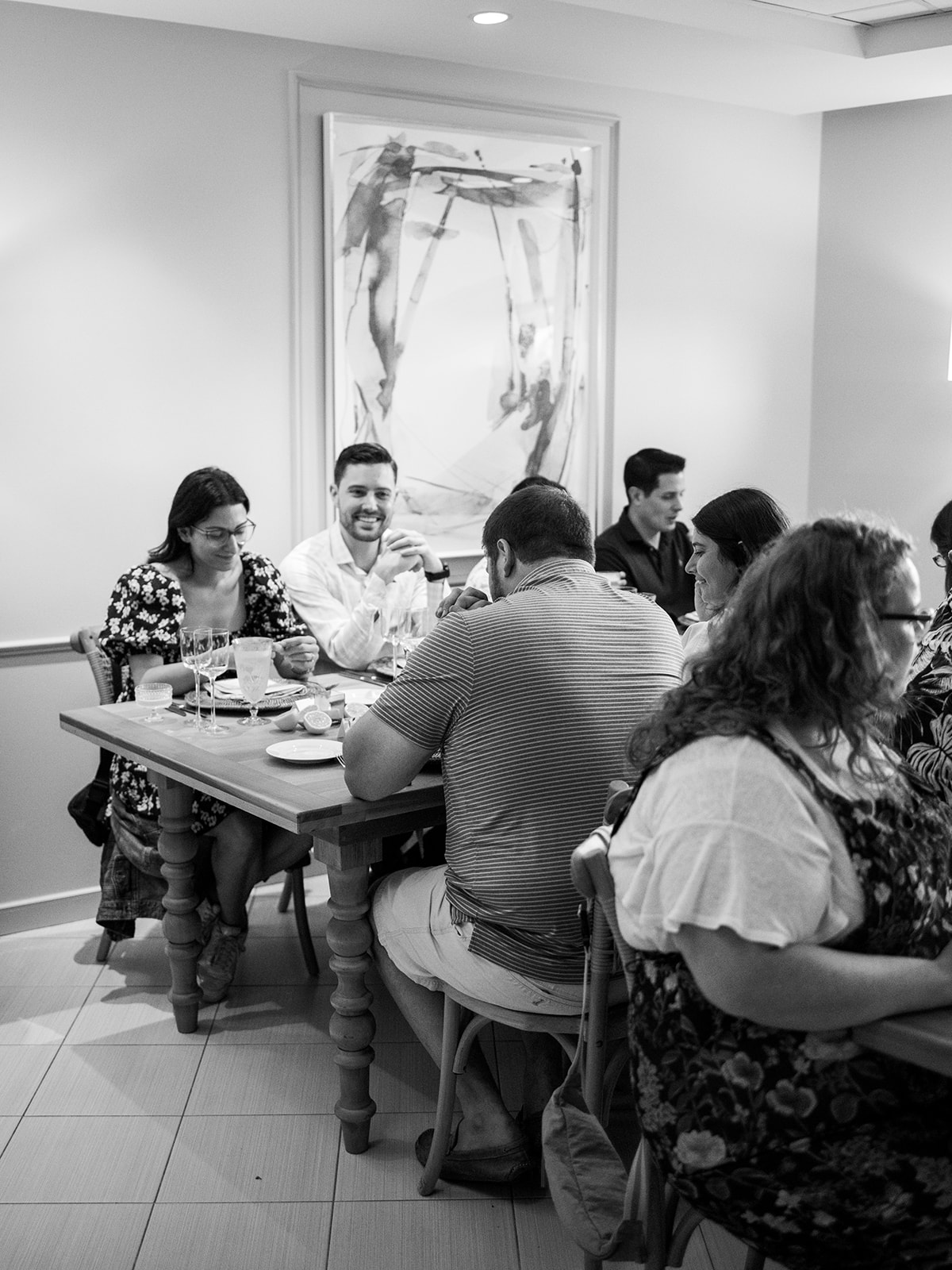 candid black and white photo of people eating at a night in Tuscany inspired event