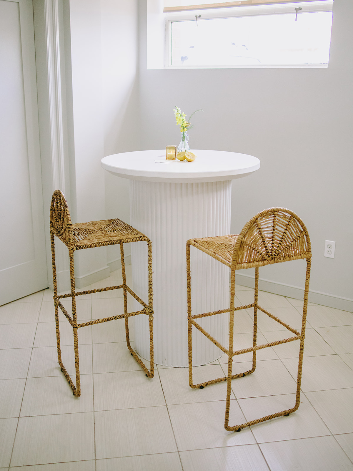 white wilhelm cocktail tables paired with the seagrass barstools